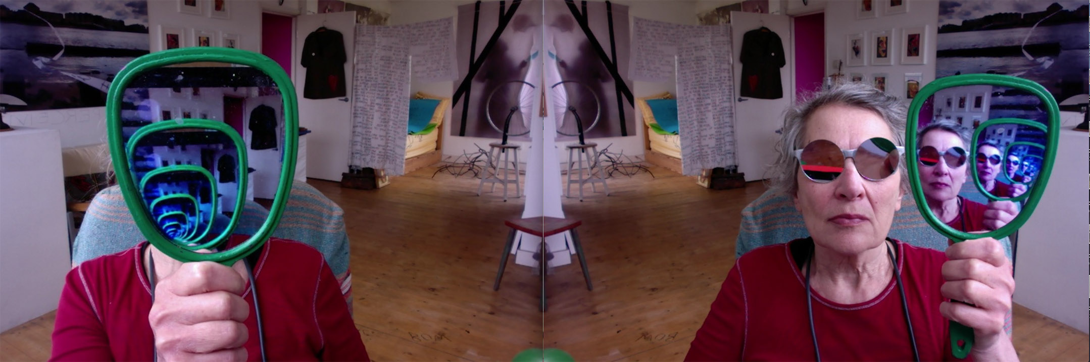 A mirror image of Anne, a white woman wearing a red jumper and holding a green handheld mirror. Anne on the left is holding the mirror infront of her face reflecting the mirror endlessly. Anne on the right is wearing circular sunglasses and holds the mirror to the side, reflecting Anne's face endlessly.