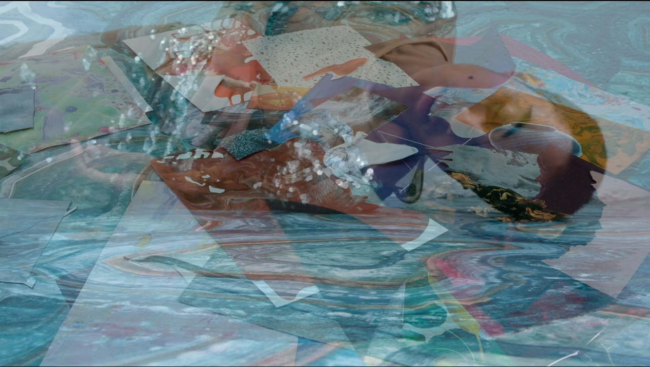 Two faded images layered on top of one another. One of Alexandrina, a black person lying on the ground on their side wearing a body suit of silver pallets. The other image